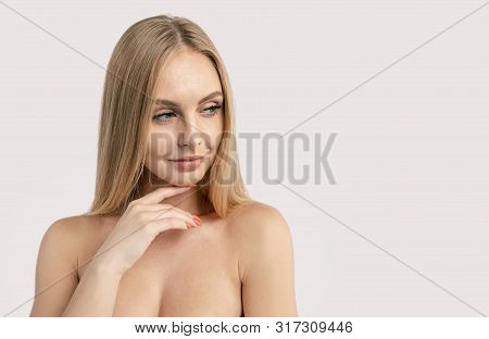 Portrait Of Skittish Blonde Girl Looking Aside With Forefinger Under Chin Copyspace Isolated White B