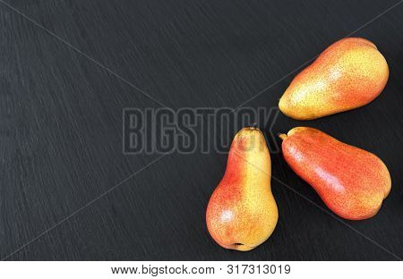 Fresh Pears On A Black Stone Table. Fruits. Free Space For Text. Top View.