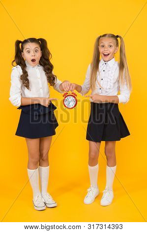 It Is Time. School Schedule. Schoolgirls And Alarm Clock. Children School Pupils. Knowledge Day. Sch