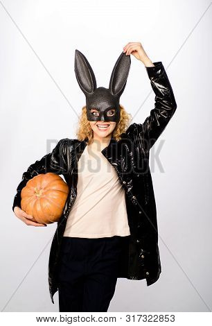 Sexy Woman In Black Bunny Mask Holding Halloween Pumpkin. Halloween Art Design. Sexy Halloween Costu
