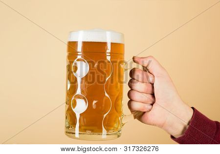 Beer In Mug With Foam. Fresh Cold Beer In Glass In Hand. Leisure, Drinks, Degustation, People And Ho