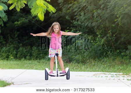 Child On Hover Board. Kids Riding Scooter
