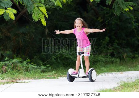 Child On Hover Board. Kids Riding Scooter