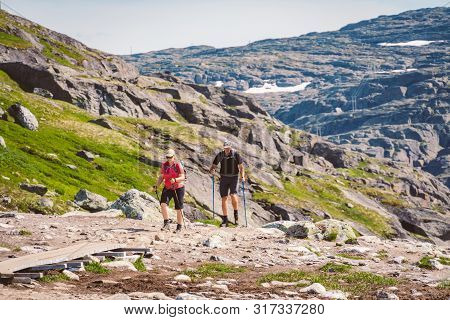 July 26, 2019. Norway Tourist Route On The Trolltunga. People Tourists Go Hiking In The Mountains Of