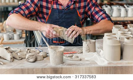 Caucasian Male Hands Making Decoration From Clay.