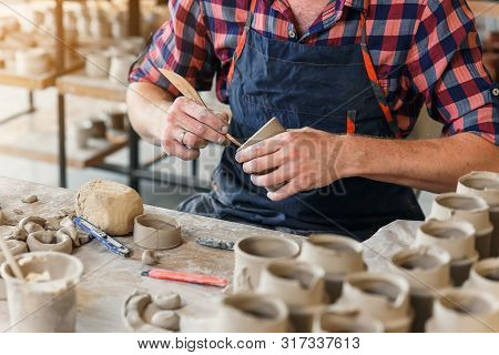 Focused Male Potter Making Something From Clay.