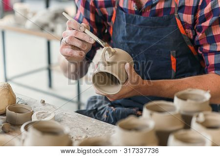 Focused Middle Age Man During Work In The Pottery.