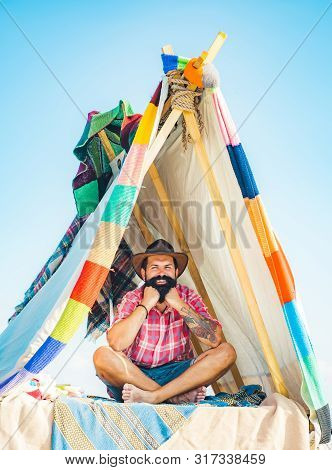 Camping Lifestyle. Camping And Tent Near Beautiful Sunlight In The Morning. Handsome Bearded Man Ins
