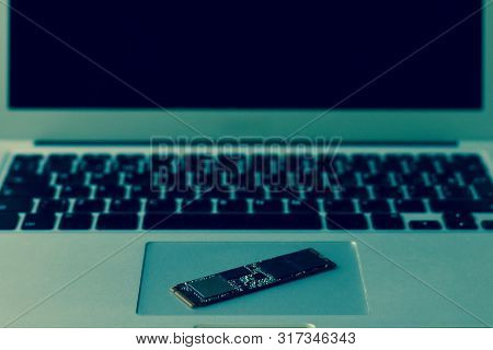 Ssd Drive Diagonally On The Trackpad. The Laptop Takes Up The Entire Frame Horizontally. Half Screen