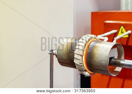 Close Up Coil And Work Piece Of High Volt Electric Induction Heating Machine To Heat Metal Pipe Or T