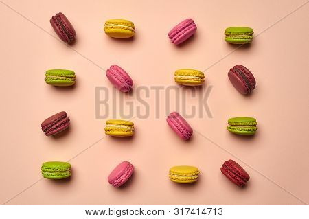 Colored Macaron Or Macaroon, Sweet Meringue-based Confection On Pink Background. Close-up, Copy Spac
