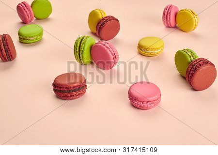 Colored Macaron Or Macaroon, Sweet Meringue-based Confection On Pink Background. Close-up, Copy Spac