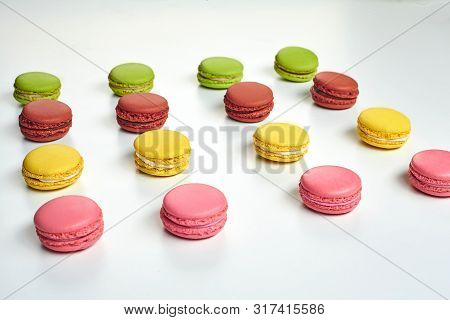 Colored Macaron Or Macaroon, Sweet Meringue-based Confection Isolated On White. Close-up, Copy Space