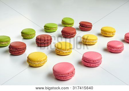 Colored Macaron Or Macaroon, Sweet Meringue-based Confection Isolated On White. Close-up, Copy Space