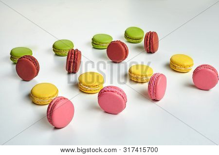 Colored Macaron Or Macaroon, Sweet Meringue-based Confection Isolated On White. Close-up, Copy Space
