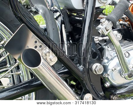 Close Up Of The Engine And Chrome Exhaust Pipe Of A Vintages Custom 1970s Scrambler Type Motorcycle