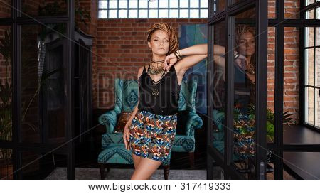 Southern Spices. Luxurious Young Woman With Afro-hairs, An Intricate Hairstyle, Blue Eyes, Highlight