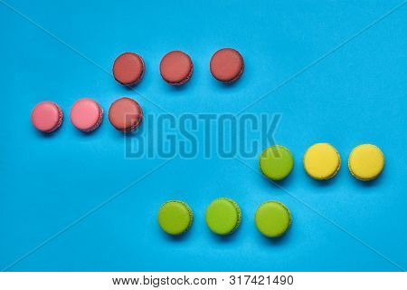 Colored Macaron Or Macaroon, Sweet Meringue-based Confection On Blue Background. Close-up, Copy Spac