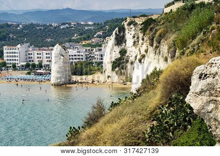 Vieste, Gargano, Apulia, Pizzomunno Monolith On The Seashore With Parasols