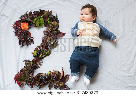 The Child Is Two Months Old. 2 Month Old Baby, 2 Months Birthday Happy. Top View, Flat Lay