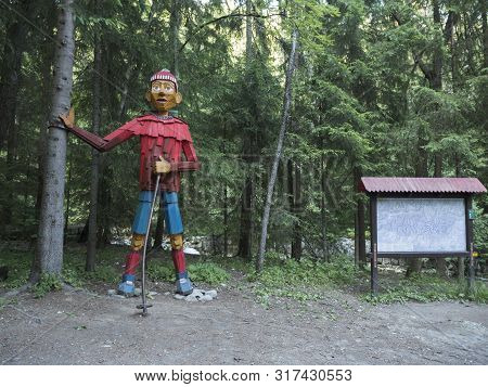 Slovakia, Western Tatra Mountain, July 3, 2019: Big Colorful Wooden Statue Wood Carving Of Hiker At 