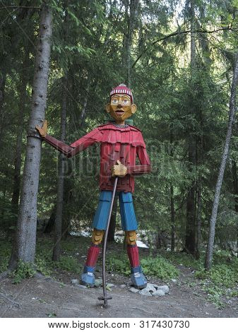 Slovakia, Western Tatra Mountain, July 3, 2019: Big Colorful Wooden Statue Wood Carving Of Hiker At 