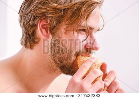 Guy Having Coffee And Holds Croissant While Lay Bed In Bedroom Or Hotel Room. Relaxation And Recreat