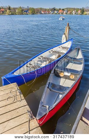 Canoes At The Stadtsee Lake In Molln, Germany