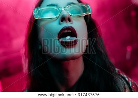 Beautiful Girl In Sunglasses With Lsd On Tongue In Nightclub