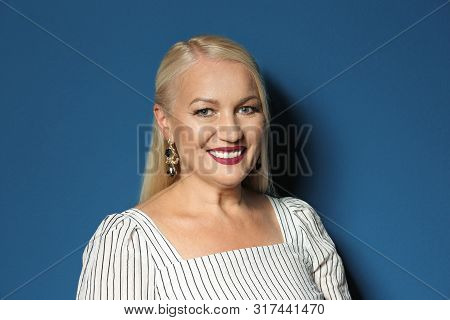 Portrait Of Beautiful Mature Woman On Blue Background