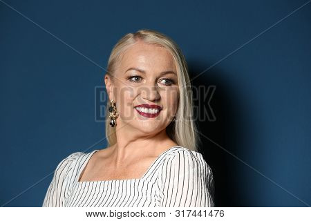 Portrait Of Beautiful Mature Woman On Blue Background