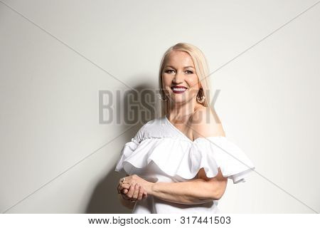 Portrait Of Beautiful Mature Woman On Light Background