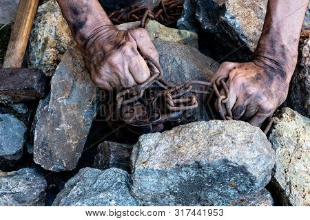 The Hands Of A Slave In An Attempt To Release. The Symbol Of Slave Labor. Hands In Chains.