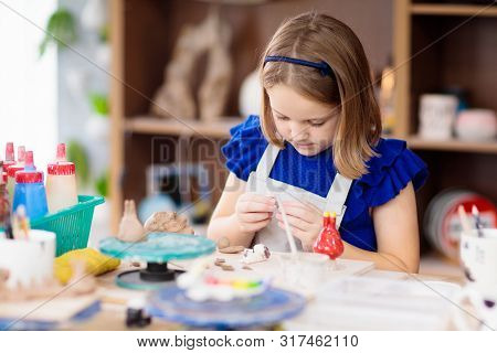 Child At Pottery Wheel. Kids Arts And Crafts Class