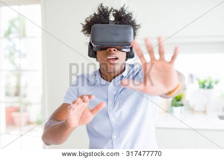 African amaerican man having fun playing with virtual reality glasses