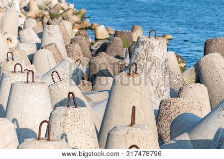 Breakwaters In Sea. Beautiful Sunset Seascape With Concrete Tetrapodes For Protect Coastal Structure