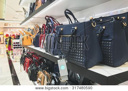 Ladies Bags Are Stacked In Shelf.
