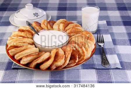Tasty, Lush Pancakes With Sour Cream And A Glass Of Milk.