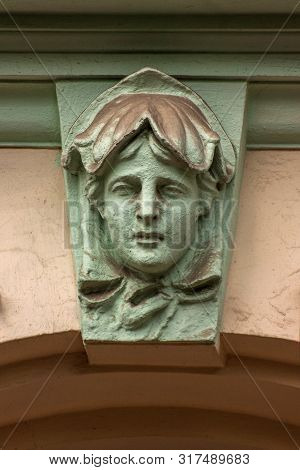 Mascaron In The Form Of Young Man On Building