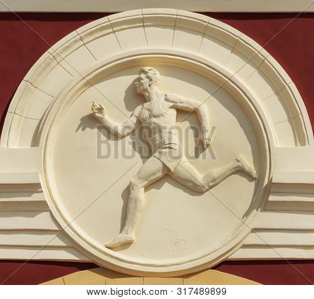 Minsk, Belarus - August 04, 2019: Bas-relief Of Running Athlete On The Wall Of Dynamo Stadium
