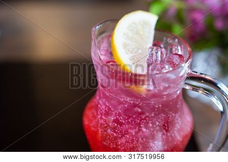 Close Up. Summer Iced Drink With Lemon Dipping In Red Juice, With Soda For Cold Drink Booster After 