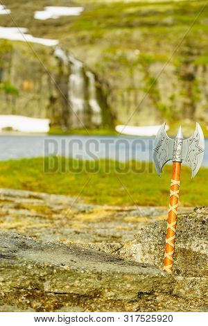 Equipment Of Viking Or Barbarian Warrior Outdoor On Nature. Viking Axe Against Norwegian Nature. Tou
