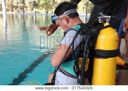 A Group Of People Doing Diving Training In A Swimming Pool In Batang / Central Java, Indonesia, Augu