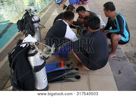 A Group Of People Doing Diving Training In A Swimming Pool In Batang / Central Java, Indonesia, Augu