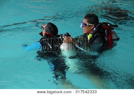 A Group Of People Doing Diving Training In A Swimming Pool In Batang / Central Java, Indonesia, Augu
