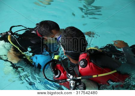 A Group Of People Doing Diving Training In A Swimming Pool In Batang / Central Java, Indonesia, Augu