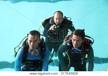 A Group Of People Doing Diving Training In A Swimming Pool In Batang / Central Java, Indonesia, Augu