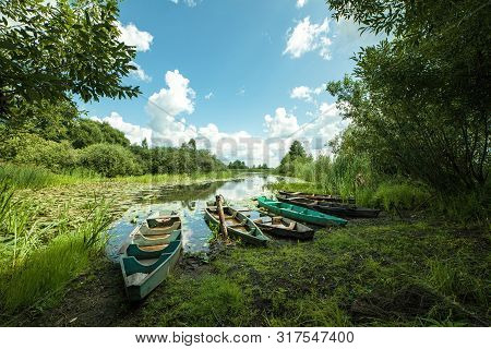 Beautiful Scenery Of Wooden Fishing Boat On The River. Fishery Boat On The River. Old Wooden Boat.