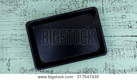 Old Vintage Baking Pan And Tins On Wooden Background. Selective Focus.