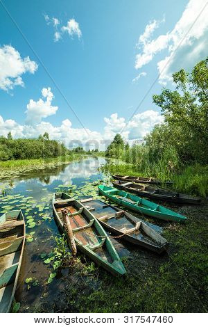Beautiful Scenery Of Wooden Fishing Boat On The River. Fishery Boat On The River. Old Wooden Boat.